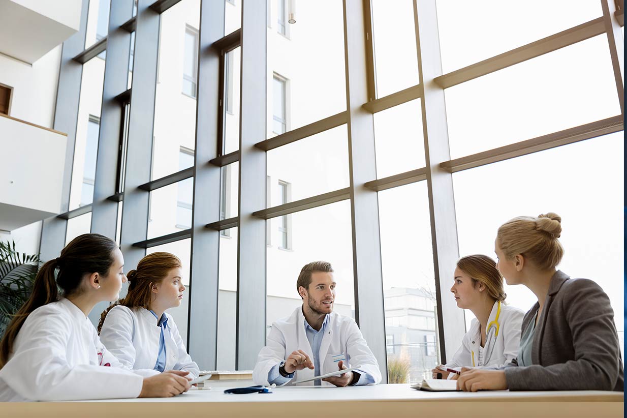 Medical team sitting around table