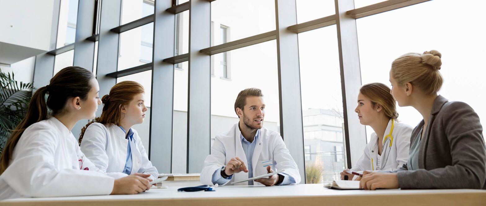 Medical team sitting around table