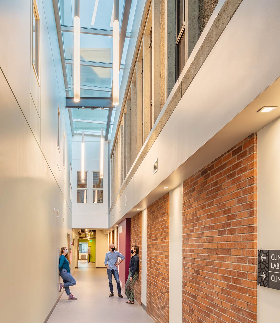 Students hanging out in double-height hallway