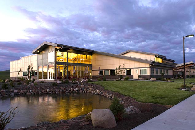 Evening exterior looking across pond at hospital