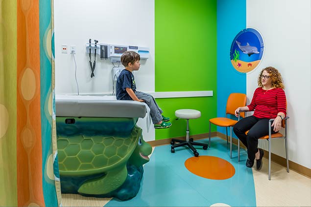 Woman and child sitting in pediatric exam room