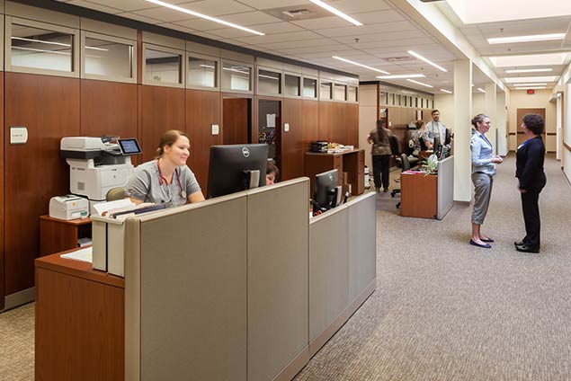 Nurses station. Two women conversing in walkway