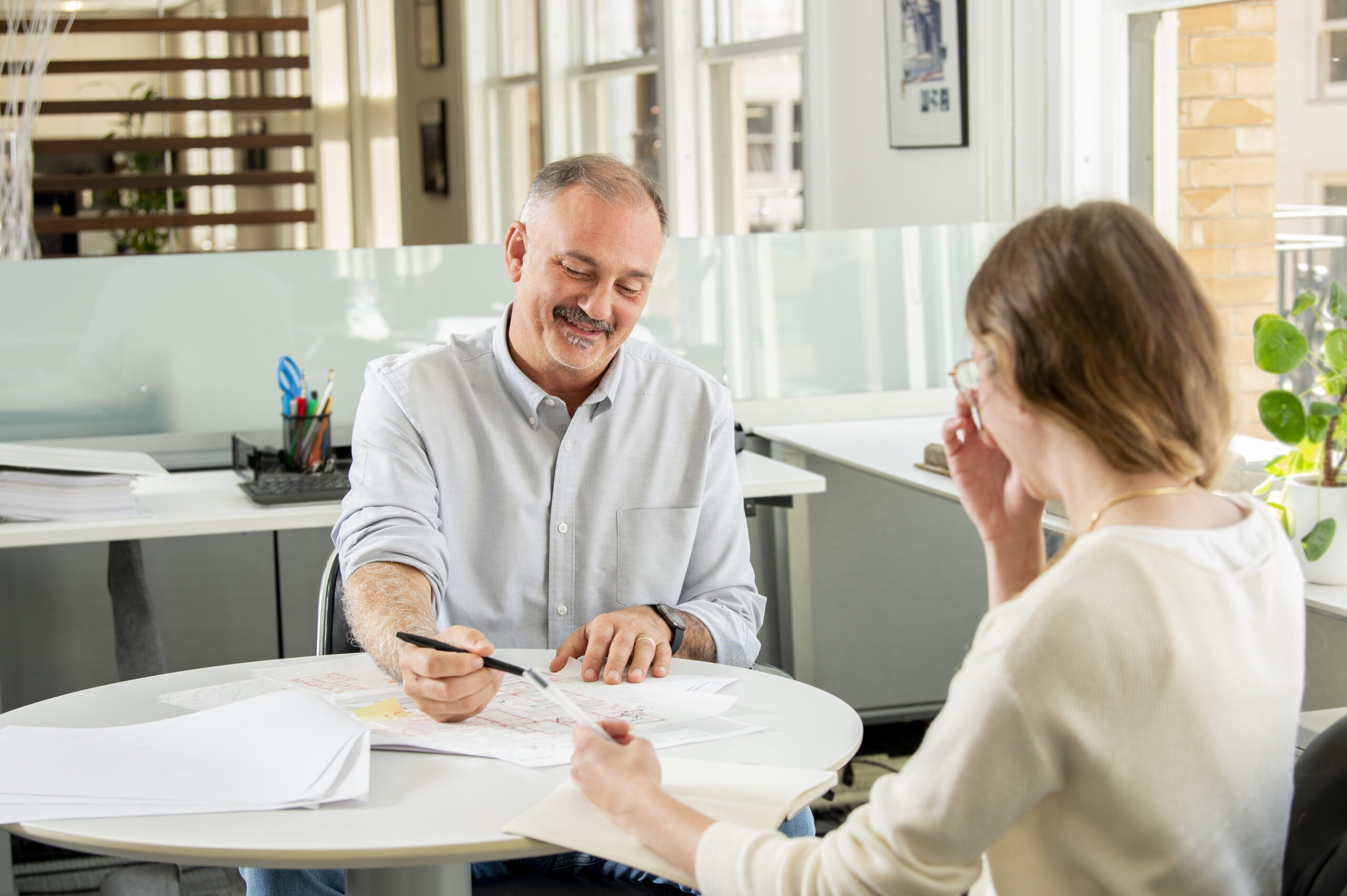 Man and woman sitting at table across from one another