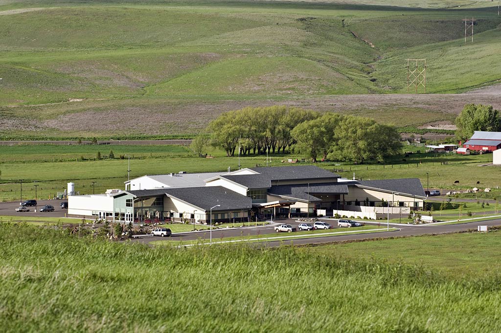 A rural healthcare center sits amidst rolling, green hills